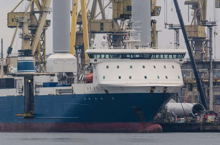 CARGO AND CONTAINER SHIP - Loading of steel structures into the cargo hold in a seaport