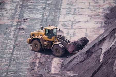 WHEEL LOADER - A machine working in the yard with mineralsの写真素材