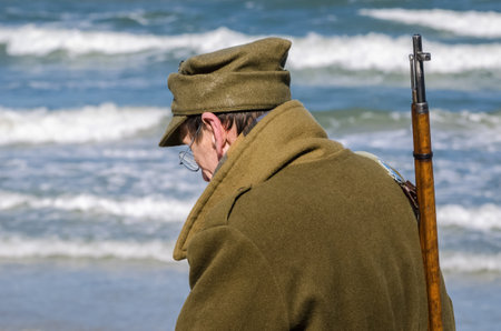KOLOBRZEG, WEST POMERANIAN / POLAND - 2018: Reconstruction of battle for Kolobrzeg - A soldier of the 1st Polish Army on the seashoreのeditorial素材
