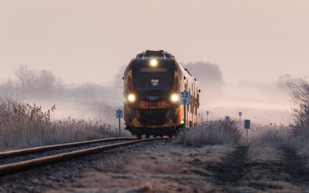 KOLOBRZEG, WEST POMERANIAN - POLAND - 2021: Modern Hybrid Multiple Unit on a trail on a foggy morningのeditorial素材