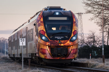 KOLOBRZEG, WEST POMERANIAN - POLAND - 2021: A modern hybrid passenger train on the railroadのeditorial素材