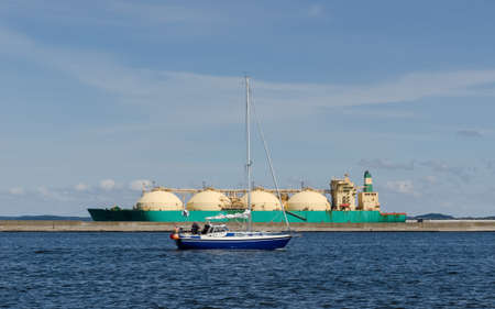 SAILBOAT AND LNG TANKER - Work and rest at seaの写真素材