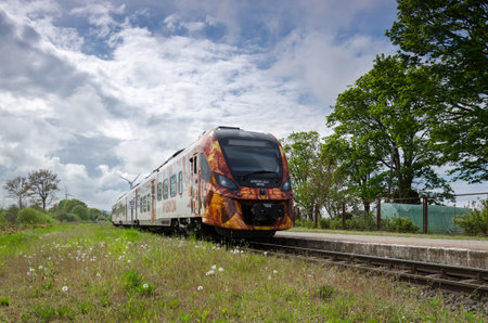 GLOWACZEWO, WEST POMERANIAN - POLAND - 2021: A modern hybrid passenger train in a small village...