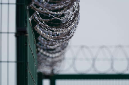 PROTECTING SITE - Separating the area with a fence and razor wireの写真素材