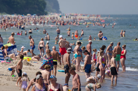 SARBINOWO, WEST POMERANIAN / POLAND - 2021: Holidaymakers relacreation on the sunny sea beachのeditorial素材