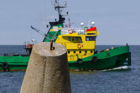DOLOS AND TUGBOAT - Coastal fortifications against the background of the auxiliary shipの写真素材