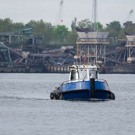 LITTLE SHIP - The auxiliary boat follows port canalの写真素材