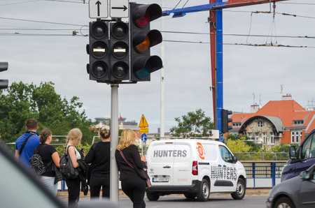 POZNAN - POLAND - 2021: Traffic lights for cars and trams at a crossroad in the city