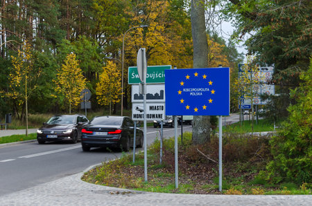 SWINOUJSCIE, WEST POMERANIAN - POLAND - 2021: State border - A blue board with information about the country membership in the European Unionのeditorial素材