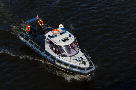 SZCZECIN, WEST POMERANIAN - POLAND - 2021: The municipal police is patrolling the river on a speedboatのeditorial素材