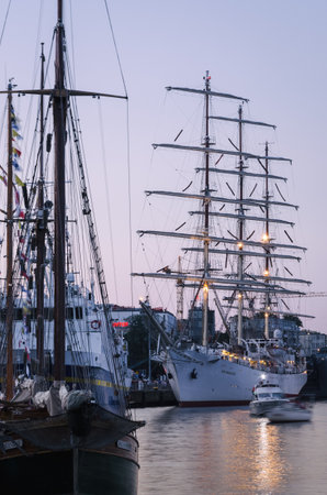 SZCZECIN, WEST POMERANIAN - POLAND - 2021; The DAR MLODZIEZY frigate and other ships moored at representative quay of seaportのeditorial素材