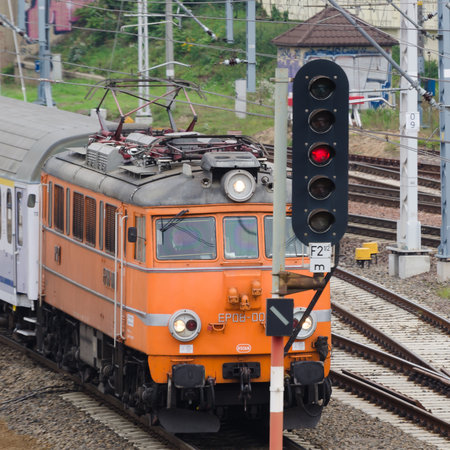 POZNAN - POLAND - 2021: Semaphore and Express train at railroad switches in front of the station