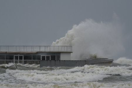 KOLOBRZEG, WEST POMERANIAN - 2022: Pier and hurricane on the sea coastのeditorial素材