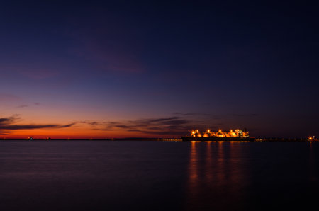 LNG TANKER - Ship at the gas terminal with sunrise