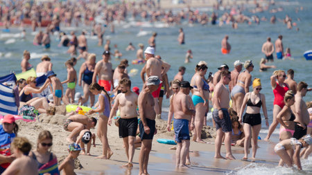 SARBINOWO, WEST POMERANIAN / POLAND - 2021: Holidaymakers relacreation on the sunny sea beachのeditorial素材