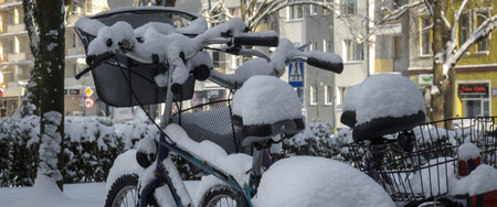 KOLOBRZEG, WEST POMERANIAN - 2021: Bicycles and the city covered in snowのeditorial素材