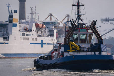 TUGBOAT AND PASSENGER FERRY - The ships sailing to portの写真素材