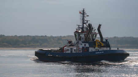 SWINOUJSCIE, WEST POMERANIAN - POLAND - 2011: Tugboat is sailing on seaのeditorial素材