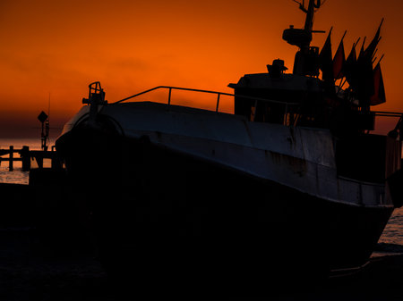 SUNSET BY THE SEA - Fishing boats on coast in the light of evening sun