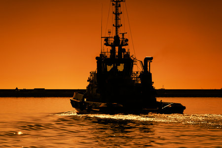 GDYNIA, POMERANIAN - POLAND - MAY 30, 2023: The tugboat maneuvers in seaportのeditorial素材