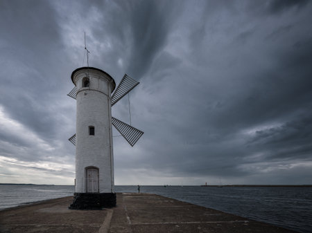 WEATHER - Rain clouds over the sea port navigation signの写真素材