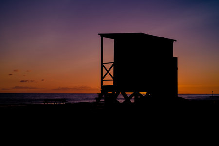 HOLIDAY RESORT - Lifeguards watchtower at dawn on sea beachの写真素材