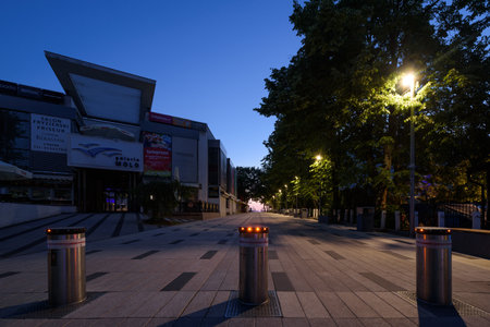 KOLOBRZEG, WEST POMERANIAN - POLAND - JULY 06, 2023: Boulevard and shopping mall in front of the walking pier in the summer at dawnのeditorial素材