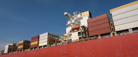 MARITIME TRANSPORT - A container ship sails with cargo to the port