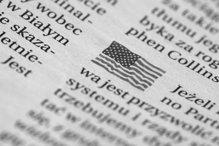 KOLOBRZEG, WEST POMERANIAN - POLAND - 08, FEBRURY, 2024: POLISH NEWSPAPER - US flag and focus box...