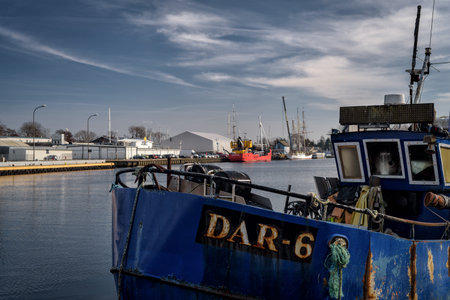 DARLOWO, WEST POMERANIAN; - POLAND - FEBRUARY 26, 2024: FISHING BOAT - A small blue ship at quay of...
