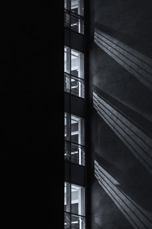 ARCHITECTURE - Building at night with light in the windowsの写真素材