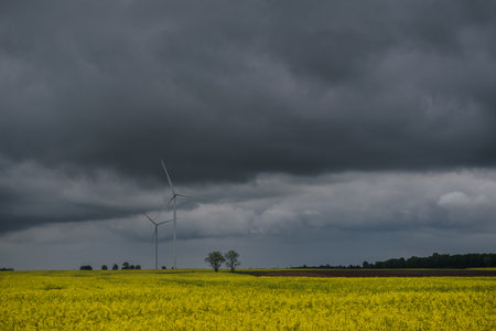 WIND FARM AND FORECAST - Dramatic black rain clouds over windmills