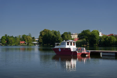 RELAXATION BY THE LAKE - Water rescuers motor boat at pier of lifeguard station on the lake