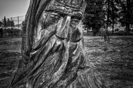 CZAPLINEK, WEST POMERANIAN - POLAND - JUNE 14, 2024: A figure of an old fisherman carved by the artist Edward Szatkowski in a poplar trunkのeditorial素材