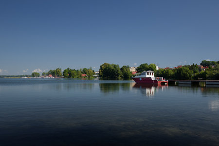 CZAPLINEK, WEST POMERANIAN - POLAND - JUNE 25, 2024: RELAXATION BY THE LAKE - Water rescuers motor boat at pier of lifeguard station on the lakeのeditorial素材