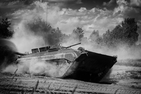 INFANTRY FIGHTING VEHICLE - Armored personnel carrier drives through forest off-road terrainの写真素材