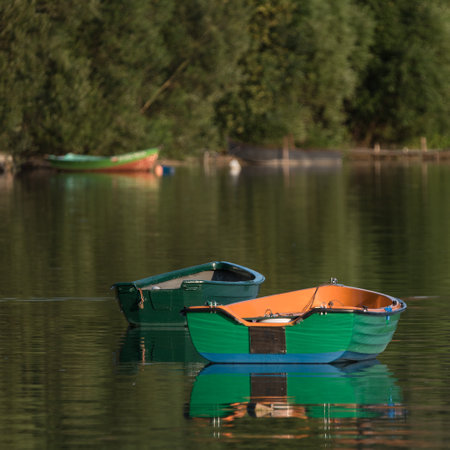 LANDSCAPE BY THE LAKE - Colorfull rowing boat on the lake