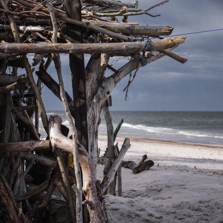 SEA COAST - A hut made of dry sticks and branches on a sunny sea beachの写真素材