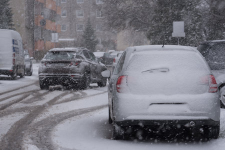 SNOWSTORM IN THE CITY - Vehicles and streets are covered with a layer of snowの写真素材