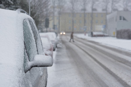 SNOWSTORM IN THE CITY - Vehicles and streets are covered with a layer of snowの写真素材