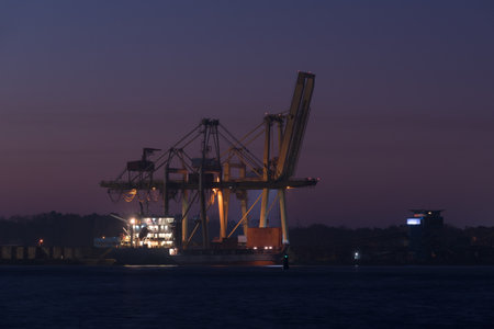 SEA PORT IN SWINOUJSCIE - The lighthouse and the quay of transshipment terminal at sunrise