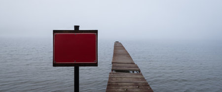 RED SIGN - Warning sign on the lake shore at the private wooden jettyの写真素材