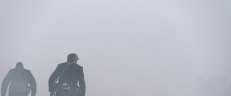 GERMANS IN BLACK UNIFORMS - Two World War II soldiers run through the smokeの写真素材