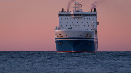 MARITIME TRANSPORT - Passenger/Ro-Ro Cargo Ship sails on the sea at sunsetの写真素材
