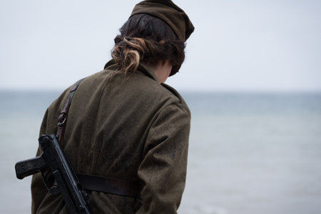 HISTORICAL RECONSTRUCTION - A female soldier of the Second Polish Army during World War II on the coast of the Baltic Seaの写真素材