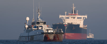MARITIME TRANSPORT - Offshore tug/supply ship and bulk carrier sailing to sea portの写真素材