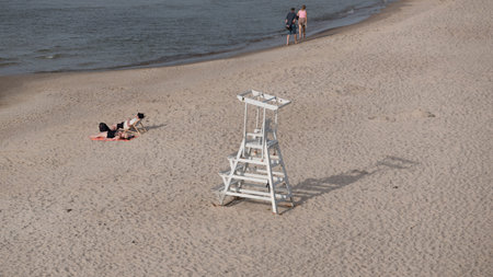 TRZESACZ, WEST POMERANIAN - POLAND - SEPTEMBER 04, 2025: Tourists walk and relax on the sea beachの写真素材