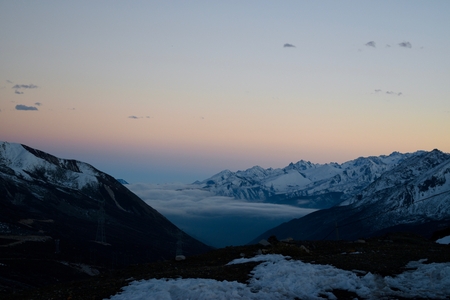 Nicely colored sky during sunset with sea of clouds and sharp mountains around. Sichuan, China.の写真素材