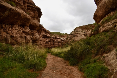 Narrow walking path between sandstones in Pingshan Grand Canyon National Park in Gansu province, Chinaの写真素材