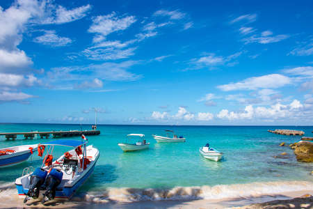 Boats with engine in the clear ocean on a background of palm trees and beautiful clouds.の写真素材